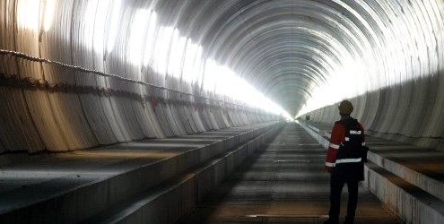 A visitor stands at the Erstfeld-Amsteg section of the NEAT Gotthard Base Tunnel October 5, 2010. With a length of 57 km (35 miles) crossing the Alps, the world's longest train tunnel should become operational at the end of 2017. REUTERS/Arnd Wiegmann (SWITZERLAND - Tags: BUSINESS CONSTRUCTION TRANSPORT TRAVEL IMAGES OF THE DAY)