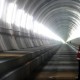 A visitor stands at the Erstfeld-Amsteg section of the NEAT Gotthard Base Tunnel October 5, 2010. With a length of 57 km (35 miles) crossing the Alps, the world's longest train tunnel should become operational at the end of 2017. REUTERS/Arnd Wiegmann (SWITZERLAND - Tags: BUSINESS CONSTRUCTION TRANSPORT TRAVEL IMAGES OF THE DAY)